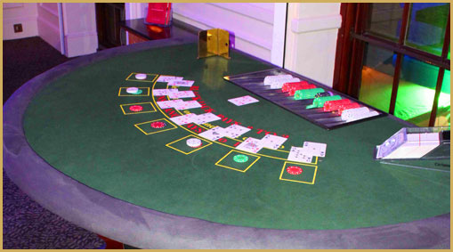 Blackjack table hire with cards dealt at a casino night